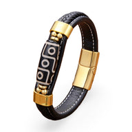 Bracelet homme en microfibre noir avec motif tibétain blanc, fermoir et détails dorés.