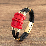 Bracelet homme en microfibre noir tressé avec ornement rouge en turquoise et fermoir doré.