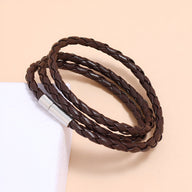 Bracelet en microfibre tressée marron à enrouler avec fermoir métallique argenté.