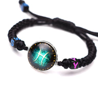 Bracelet en nylon noir tressé avec médaillon signe du zodiaque Poissons bleu turquoise et jaune.