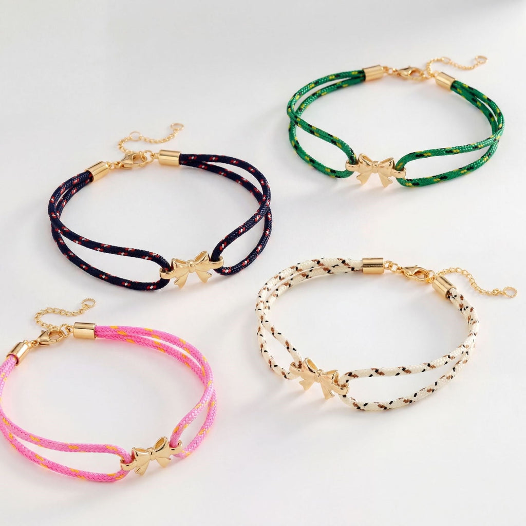 Pulsera de nailon trenzado con charm de lazo dorado, accesorio femenino ajustable y refinado, ideal para un look chic y espontáneo, modelo Rubane