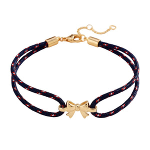 Pulsera de nailon trenzado con charm de lazo dorado, accesorio femenino ajustable y refinado, ideal para un look chic y espontáneo, modelo Rubane