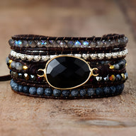 Bracelet multi-rangs noir avec pierre d'onyx facettée, perles d'agate, et rangées de strass éclatants.