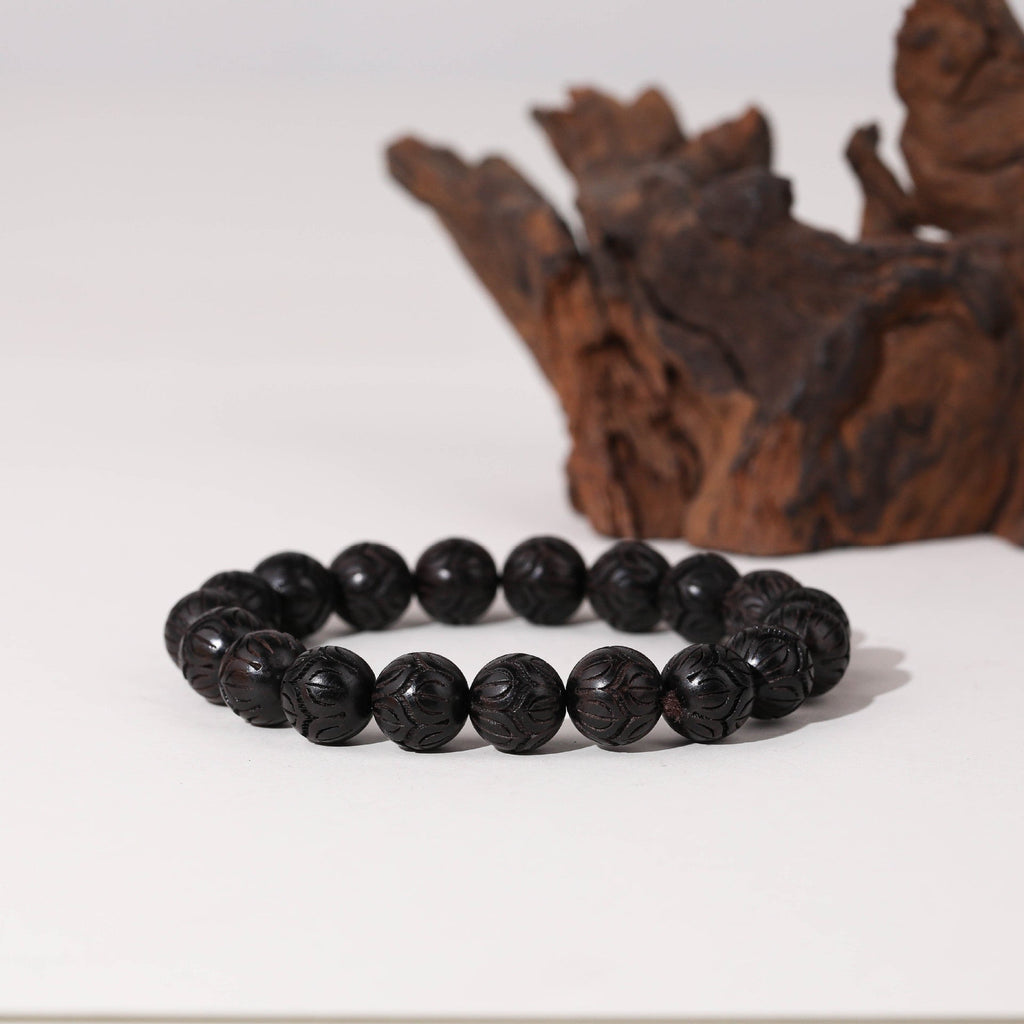 Bracelet unisexe en perles rondes de bois d'ébène noir au fini brillant, modèle Clémence.