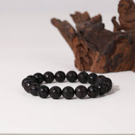 Bracelet unisexe en perles rondes de bois d'ébène noir au fini brillant, modèle Clémence.