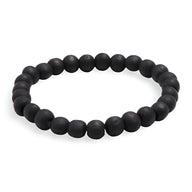 Bracelet mixte en perles de bois lisses noires, style sobre et naturel.