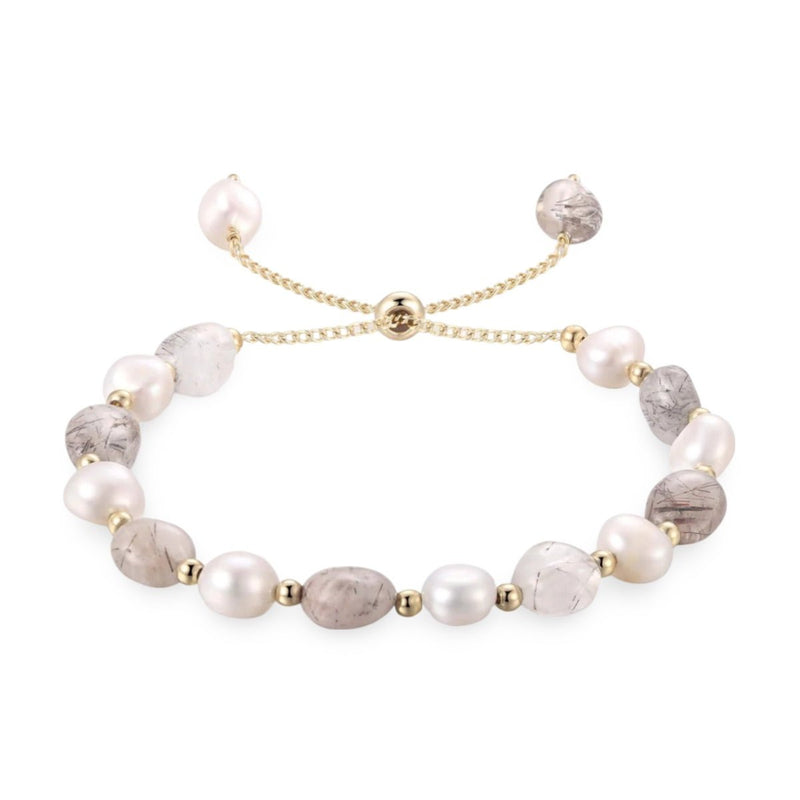 Bracelet ajustable en perles d'eau douce blanches et pierres grises aux nuances naturelles avec chaîne dorée fine.