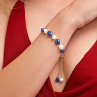 Bracelet ajustable perles d'eau douce bleu marine et blanches avec fermoir doré élégant.