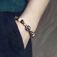 Bracelet pour femme en perles blanches d'os de yak, bois d’ébène noir et perles dorées, style ethnique.