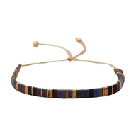 Bracelet ajustable en perles japonaises marron, bleu, jaune et noir avec cordon beige.