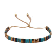 Bracelet ajustable pour femme en perles japonaises bleues, marron et beige avec cordon beige.