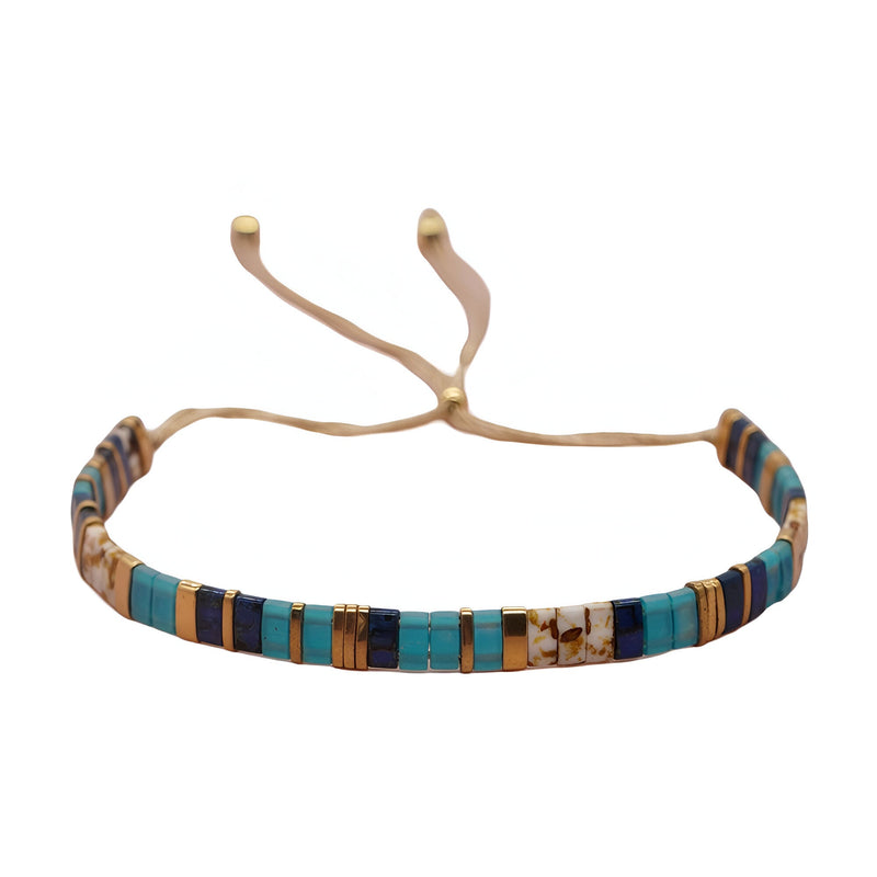 Bracelet ajustable pour femme en perles japonaises bleues, marron et beige avec cordon beige.