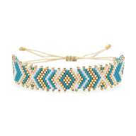 Bracelet bleu ajustable en perles du Japon arrondies avec motif géométrique et détails dorés.