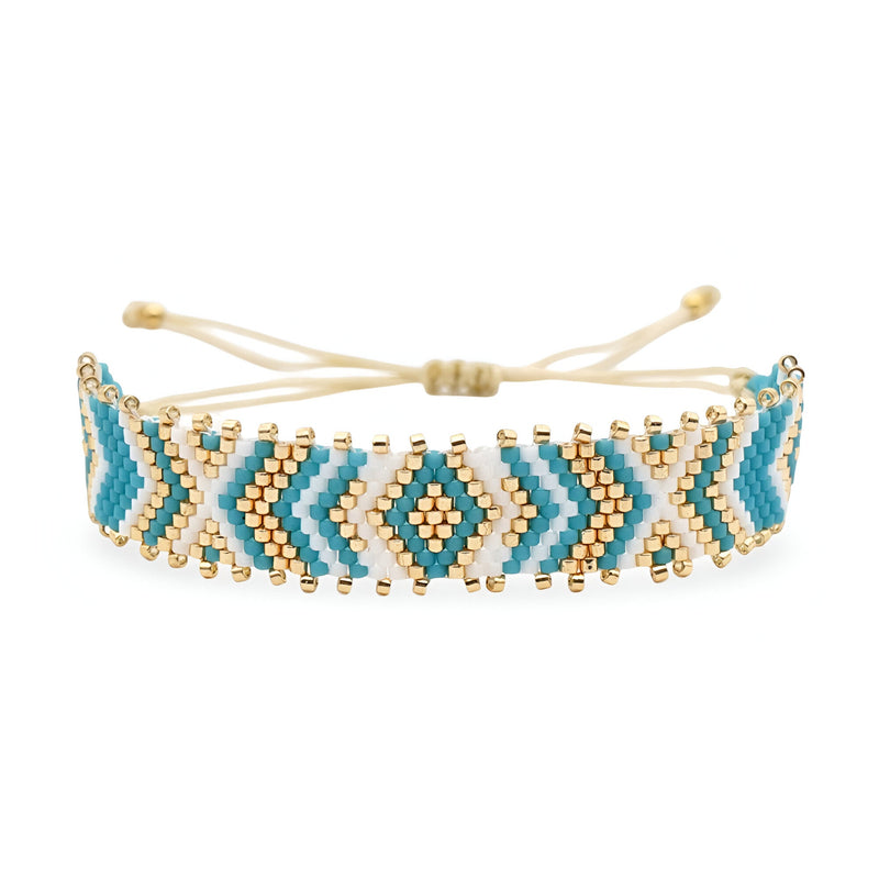 Bracelet bleu ajustable en perles du Japon arrondies avec motif géométrique et détails dorés.