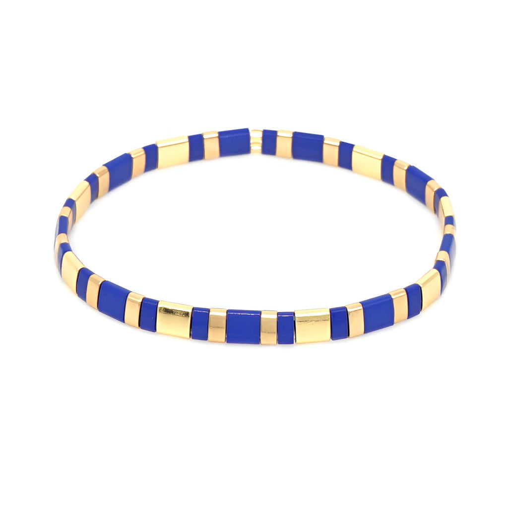 Bracelet fin en perles bleues et dorées alternées, style moderne et élégant pour femme.