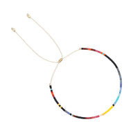 Bracelet fin en perles multicolores japonaises avec lien coulissant doré.