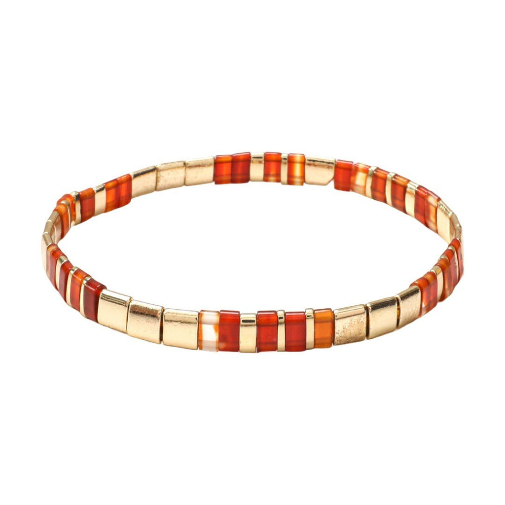 Bracelet souple à enfiler en perles japonaises dorées et rouges, effet lumineux, style raffiné.