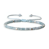 Bracelet mixte perles heishi en aigue-marine bleu clair avec fermoir ajustable en coton tressé.