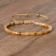 Bracelet mixte en perles heishi aventurine orange et dorées, fermoir ajustable en métal rose gold.