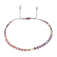 Bracelet femme perles heishi violet dégradé avec cristaux dorés et cordon réglable noir.