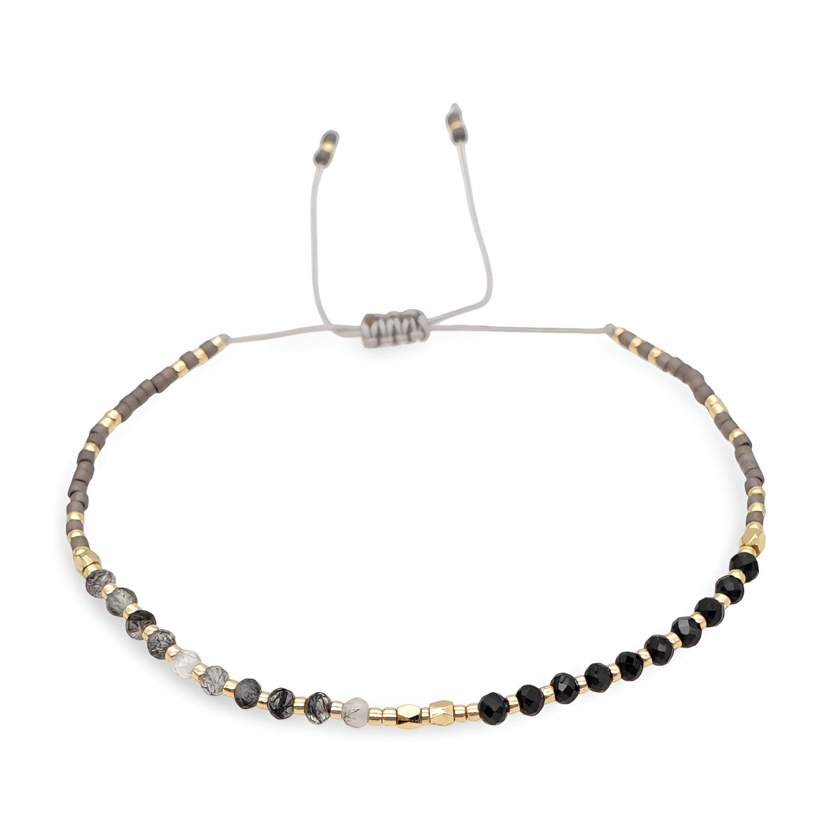 Bracelet réglable perles heishi noires et grises avec petits cristaux dorés et argentés.