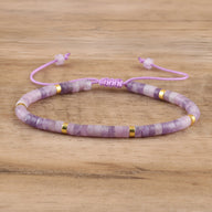 Bracelet mixte en perles heishi violettes en lépidolite avec accents dorés et cordon ajustable rose pâle.