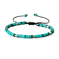 Bracelet ajustable en perles heishi turquoise tacheté et détails argentés sur cordon noir.