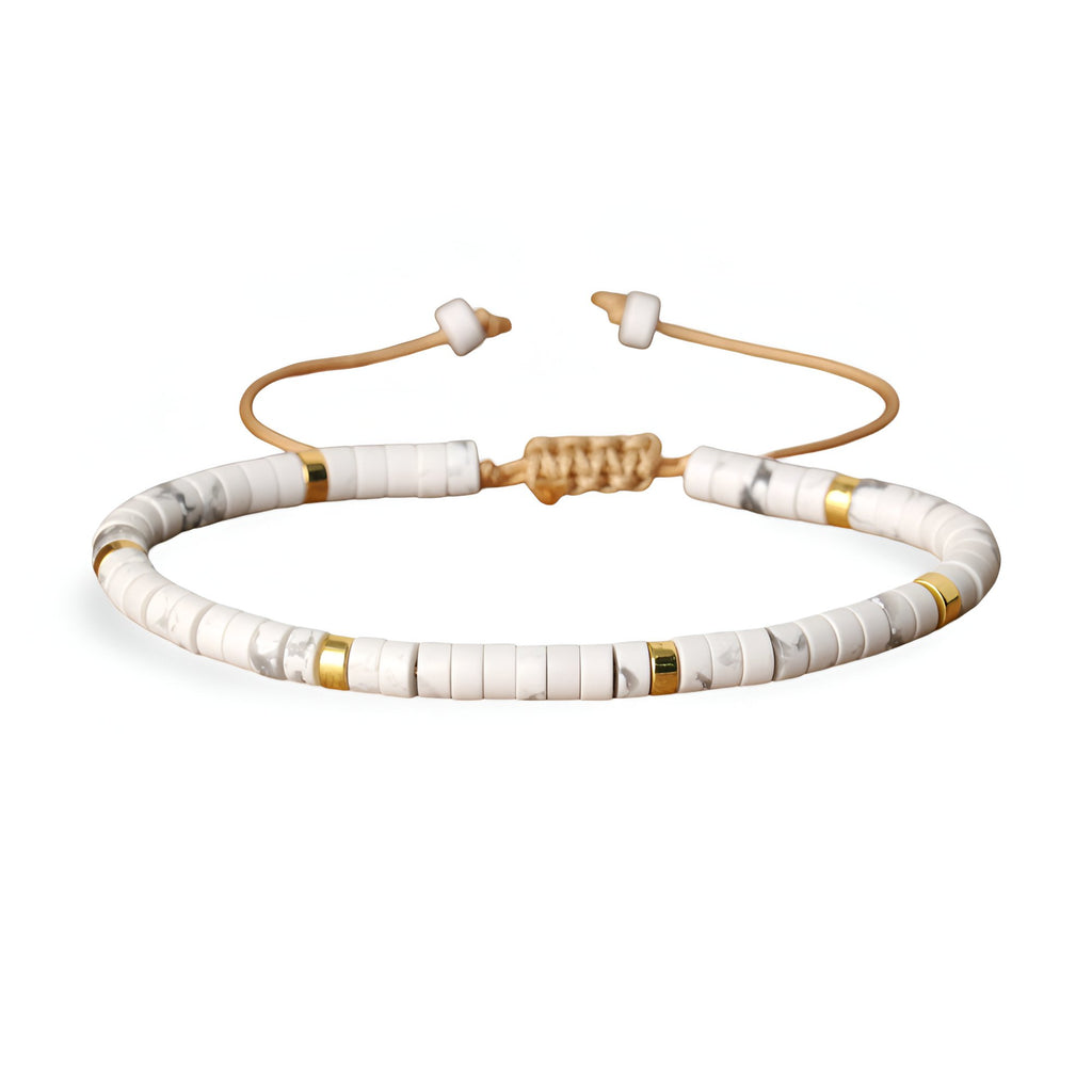 Bracelet mixte en perles heishi blanches avec accents dorés et cordon beige réglable.