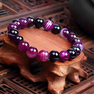 Bracelet mixte en pierre d'agate violet brillant avec perles rondes lisses et facettées.