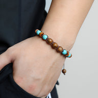 Bracelet mixte en bois et pierres naturelles œil de tigre et turquoise, style perles lisses.