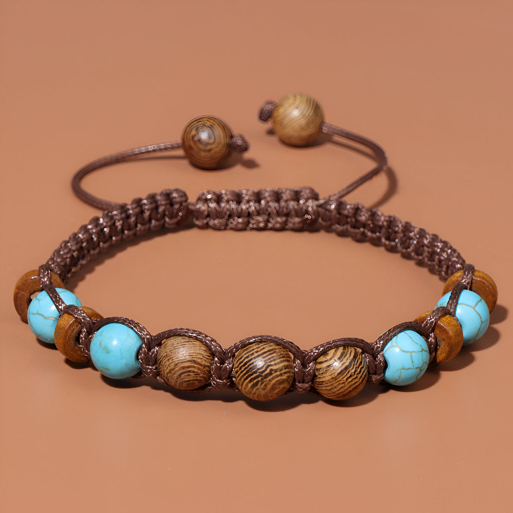 Bracelet mixte en perles de bois brun et pierre turquoise sur lien tressé marron.