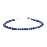 Bracelet fin en lapis-lazuli bleu foncé à perles facettées et fermoir argenté.