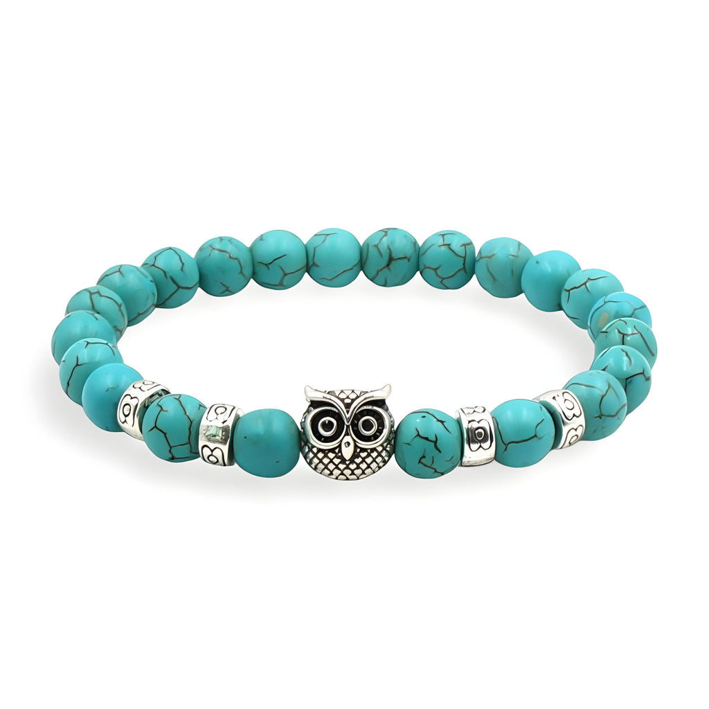 Bracelet turquoise en pierres naturelles avec perles argentées et pendentif hibou détaillé en métal.