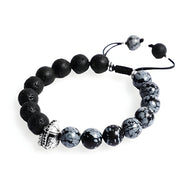 Bracelet homme avec perles en pierre volcanique noire et jaspe noir tacheté blanc, ornement casque spartiate argenté.