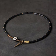 Bracelet femme en pierres d'agate noires, accents en cuivre, fermoir original spirale et perles dorées.