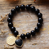 Bracelet élastique en pierres naturelles d'onyx noir 10mm avec pendentifs cœur noir et médaille dorée gravée.