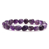 Bracelet élastique en pierres d’améthyste lisses et ovales violettes, style asymétrique.