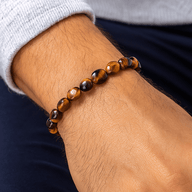 Bracelet asymétrique en perles d’œil de tigre poli, tons marron et doré, style naturel et élégant.