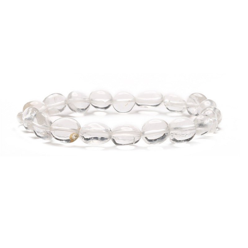 Bracelet asymétrique en quartz clair lisse aux perles rondes de tailles variées.