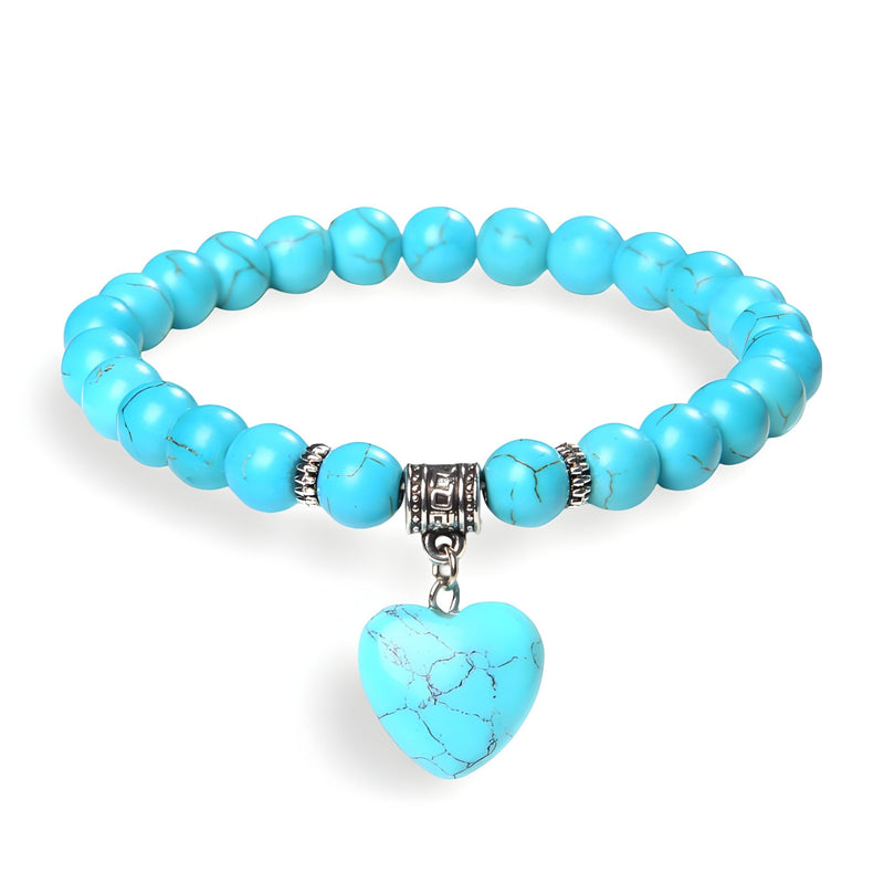Bracelet mixte à perles turquoise avec pendentif cœur en pierre naturelle bleu veinée et détails métalliques argentés.