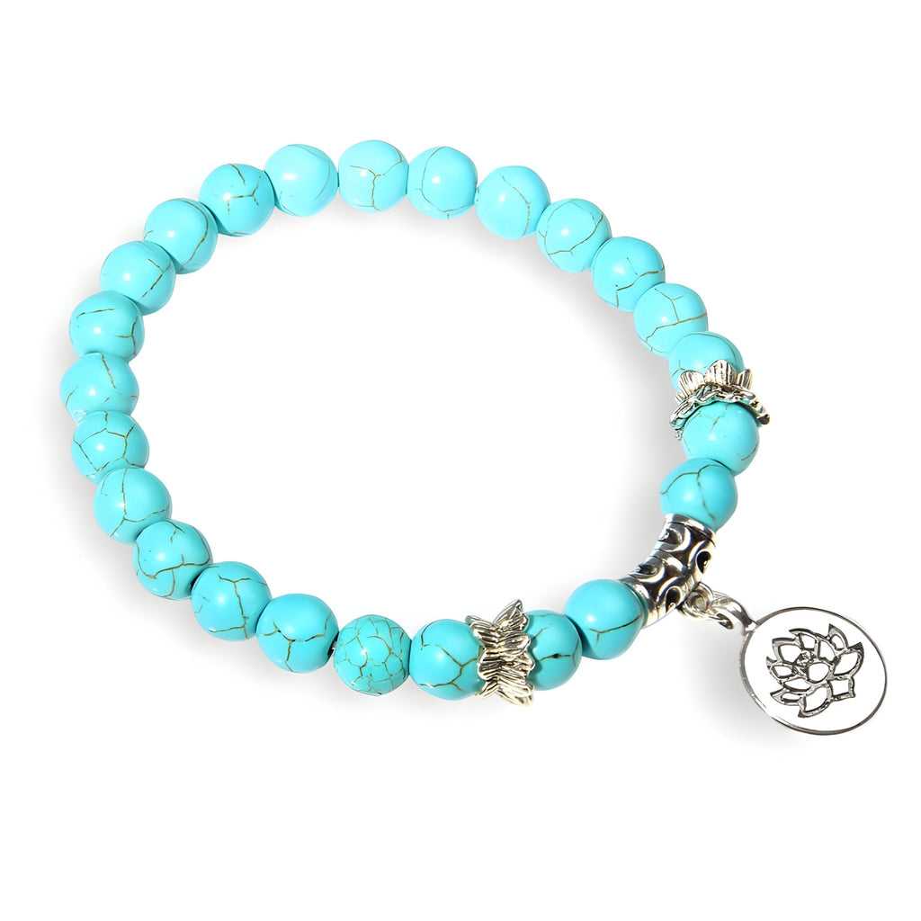 Bracelet mixte en pierres turquoise ronde avec charm fleur de lotus en métal argenté.
