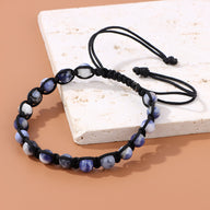 Bracelet mixte entrelacé corde noire avec pierres naturelles bleu foncé et blanc.