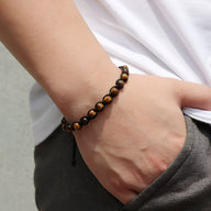 Bracelet mixte en œil de tigre, perles lisses entrelacées de corde noire ajustable.