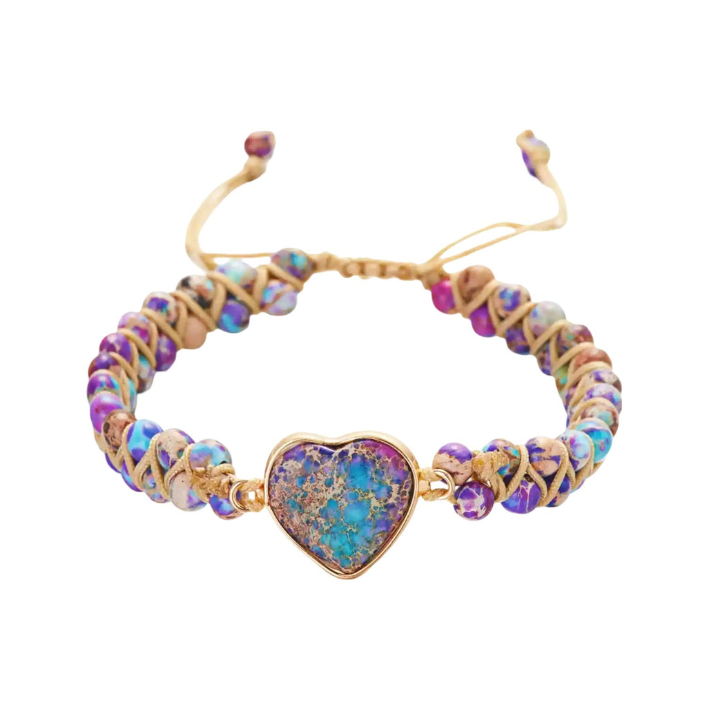 Bracelet avec pendentif cœur en pierre naturelle bleue et fil beige entrelacé, style ajustable.