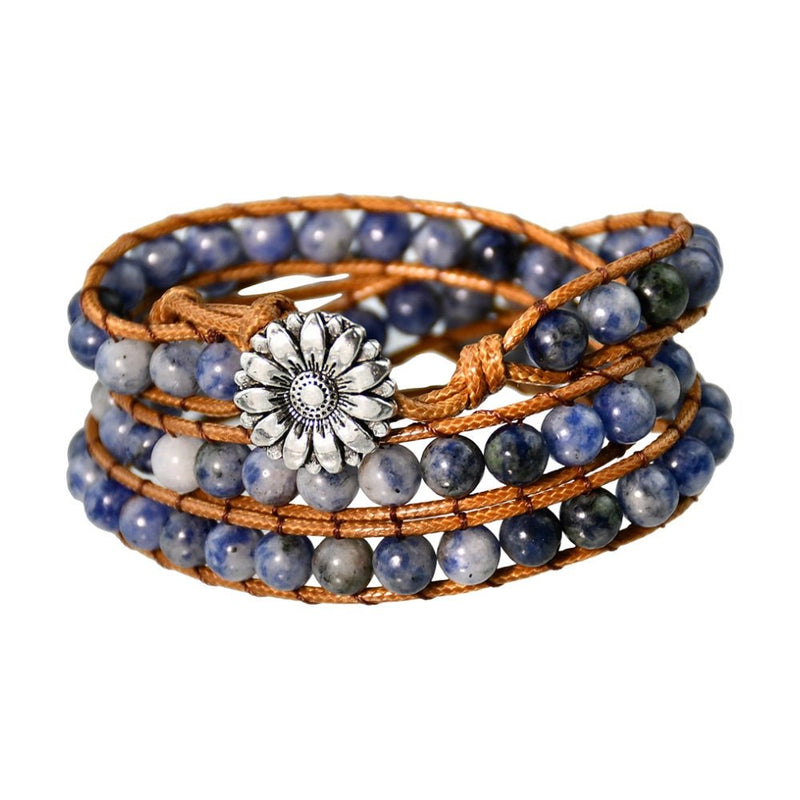 Bracelet multiple tours en jaspe bleu avec perles rondes et bouton fleur en métal argenté sur corde marron.