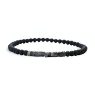 Bracelet fin pour homme en pierres naturelles noires mates et nacrées, style minimaliste.