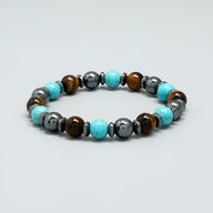 Bracelet mixte en perles rondes turquoise, œil de tigre brun et hématite gris métallisé.