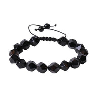 Bracelet réglable en pierres noires taillées, finition brillante, style moderne et élégant.