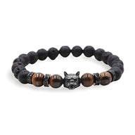 Bracelet homme en pierres volcaniques noires et perles œil de tigre marron, tête de loup argentée au centre.