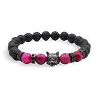 Bracelet homme en pierres volcaniques noires et perles œil de tigre rose, tête de loup argentée au centre.